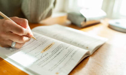 Woman completing workbook with a pencil