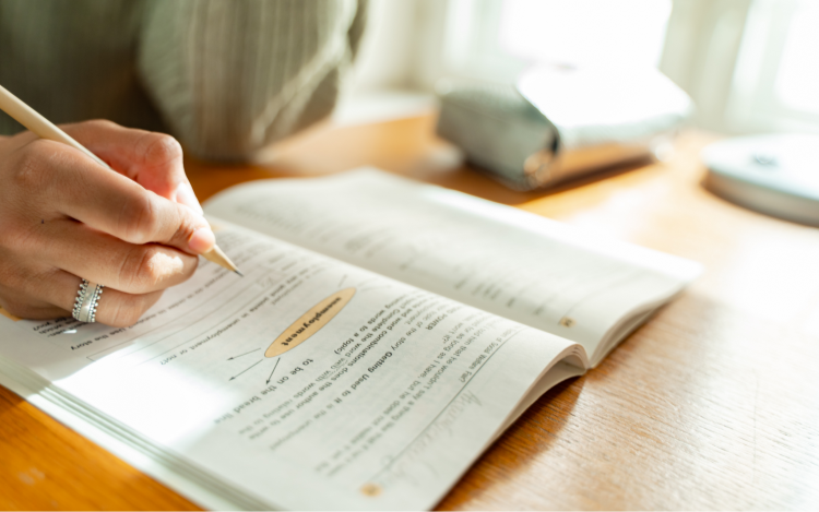 Woman completing workbook with a pencil